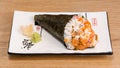 Temaki, nori seaweed cone stuffed with rice, salmon and caviar accompanied by wasabi and gari Royalty Free Stock Photo