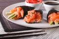 Temaki salmon sushi with soy sauce and pickled ginger close up. Royalty Free Stock Photo