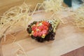 Temaki Sushi Maguro Tuna Hand Roll wrapped Mamenori seaweed served on wooden board with decorative straw