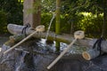 Temizuya and water scoops in front of the Izumi shrine in Suizenji Garden