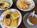 Tempe Goreng or Tempe Mendoan, fried tofu, fried bananas on a wooden table Royalty Free Stock Photo