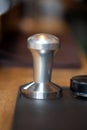 Temper for espresso holder standing on rubber pad, closeup