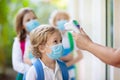 Temperature check at school. Child in mask