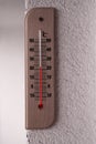 Thermometer is showing over 20 degree Celsius on white rough wall Royalty Free Stock Photo