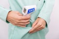 Temperature measurement gun in doctor hands. Close-up shot of doctor wearing protective surgical mask ready to use