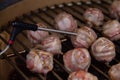 Temperature probe measuring inside temp from meatballs with bacon on BBQ Royalty Free Stock Photo