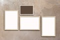 Template of blank posters in wooden frames on texturized brown stucco wall Royalty Free Stock Photo