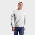 Template of blank textile sweatshirt on a man in blue jeans, isolated on a white background, walking, front view Royalty Free Stock Photo