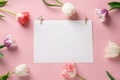 Template with blank white paper with colorful flowers on a pink background.