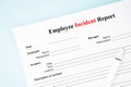 The Template of an Employee incident report form document and and pen on blue background