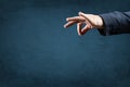 Template image. man`s hand holds an empty space with two fingers. manipulation concept. blue background. copy space Royalty Free Stock Photo