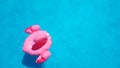 Template for an invitation to a summer party near the pool. Inflatable pink flamingo swims in clear blue azure water