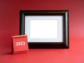 Template for photo frame for card with small red desk calendar with 2023 year number on red background. Royalty Free Stock Photo