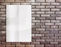Template- White crumpled Poster on grunge brick wall and leave Royalty Free Stock Photo