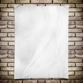Template- White crumpled rectangle Poster on grunge brick wall Royalty Free Stock Photo