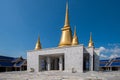 The temple building with gilded stupas on the roof against the blue sky without clouds. Royalty Free Stock Photo