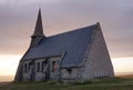 Temple church made of stone by the evening sea, the light is on in the window. Rouen city, France 07.20.2019