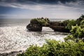 Temple on a cliff rock in the sea. Tanah lot temple. Hindu temple on a rock with a natural arch in the ocean Royalty Free Stock Photo