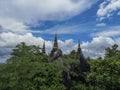 Temple in clouds with pagodas perched high on top of a rocky hill, Wat Chalerm Prakiat temple in Lampang province