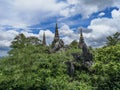 Temple in clouds with pagodas perched high on top of a rocky hill, Wat Chalerm Prakiat temple in Lampang province