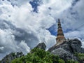 Temple in clouds with pagodas perched high on top of a rocky hill, Wat Chalerm Prakiat temple in Lampang province