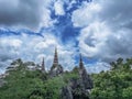 Temple in clouds with pagodas perched high on top of a rocky hill, Wat Chalerm Prakiat temple in Lampang province