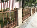 Temple compound wall with brick pillars and straight rods in between in Traditional hindu religion