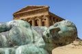 Temple of Concordia, with bronze sculpture of fallen Icarus by Igor Mitoraj. Temples Valley. Agrigento, Sicily, Italy