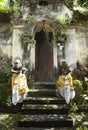 Temple entrance with bedogol guardian carved stone statues in Bali, Indonesia.