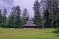 A Temple in Green meadows in himalayas, Great Himalayan National Park, Sainj Valley, Himachal Pradesh, India Royalty Free Stock Photo