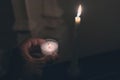 In the temple, the hand holds a candle