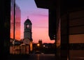 Historic church bell reflecting vibrant colors at sunset