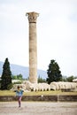Temple of Olympian Zeus, Ruins of the ancient Temple of Olympian Zeus in the center of Athens, Greece. A tourist walks on ancient
