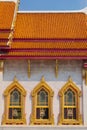 Temple of Wat Benchamabophit, located in Bangkok, Thailand. Architectural detail of the ornate golden windows.