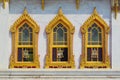 Temple of Wat Benchamabophit, located in Bangkok, Thailand. Architectural detail of the ornate golden windows.