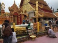 Banggok, Thailand, 10-6-2015: temples of thailand showing buddahs, people visiting the temple and loads of golden colored