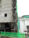 Temporary access and metal staircase made from staging and scaffolding the construction site.