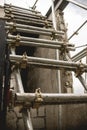 A temporary and makeshift stair made from metal tube scaffolding made to access an upper level of a building under construction.