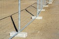 Temporary metallic portable fence with concrete base blocks to limit the territory Royalty Free Stock Photo