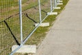 Temporary metallic portable fence with concrete base blocks to limit the territory Royalty Free Stock Photo