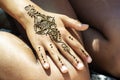 Henna tattoo drawing mehendi on girl& x27;s hand Royalty Free Stock Photo