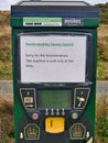 A temporary paper printed sign on a parking meter at Newgale Beach on the Pembrokeshire Coast in Wales