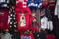 A temporary seasonal display of ugly Christmas sweaters at a retail store