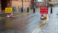 Temporary traffic signage beside rising ant terror bollards Royalty Free Stock Photo