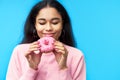 Temptation food. Pretty black woman enjoy donut