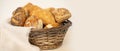 tempting array of buns, cheese and poppy seed rolls, pretzels, and cottage cheese pies presented in rustic basket panorama with Royalty Free Stock Photo