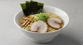 a tempting bowl of ramen with pork and seaweed on a light grey background - generated using ai Royalty Free Stock Photo