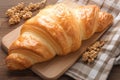 Tempting close up of a croissant bread elegantly arranged on wood