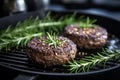 Tempting close up of a perfectly grilled and juicy meat burger patty on a sizzling hot pan