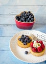 Tempting fruit desserts on a blue plank table Royalty Free Stock Photo